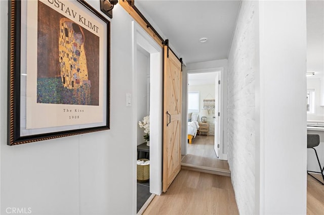 56622 Handley Rd, Yucca Valley, CA 92284 - hall featuring a barn door and light wood-type flooring