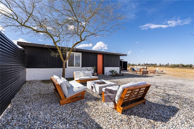 view of patio featuring an outdoor living space with a fire pit