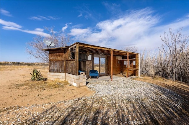 view of home's exterior featuring an outbuilding