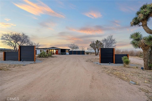 view of street with dirt driveway