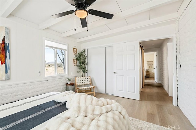 56622 Handley Rd, Yucca Valley, CA 92284 - bedroom with wood finished floors, beamed ceiling, a closet, and a ceiling fan