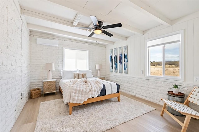 56622 Handley Rd, Yucca Valley, CA 92284 - bedroom with wood finished floors, beamed ceiling, a wall unit AC, brick wall, and a ceiling fan