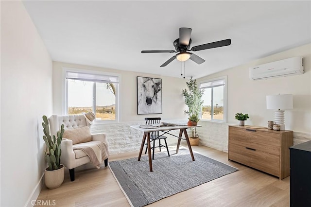 56622 Handley Rd, Yucca Valley, CA 92284 - office featuring a wall mounted AC, light wood-style flooring, and ceiling fan