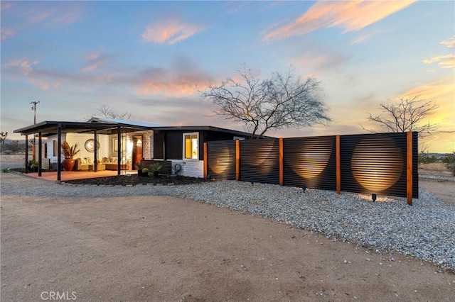 56622 Handley Rd, Yucca Valley, CA 92284 - back of house at dusk featuring a porch