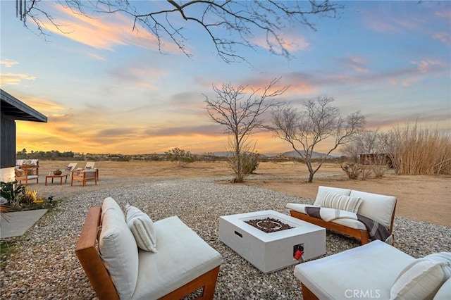 56622 Handley Rd, Yucca Valley, CA 92284 - patio terrace at dusk with a patio area and an outdoor living space with a fire pit