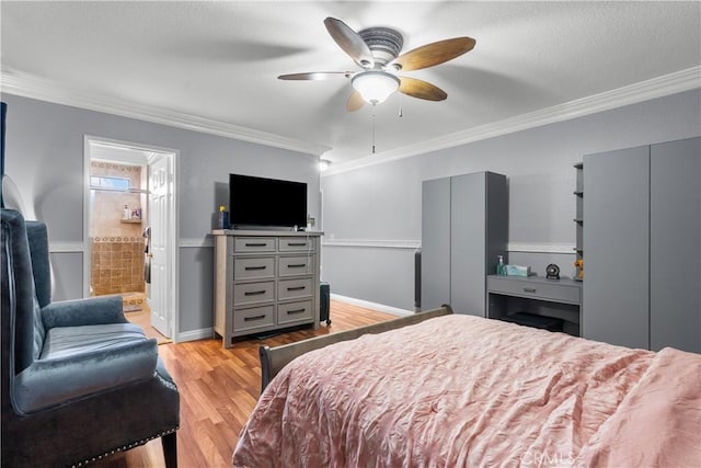 bedroom with light wood-type flooring, crown molding, and baseboards