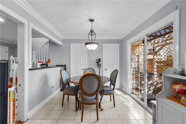 dining room with ornamental molding, baseboards, and light tile patterned floors