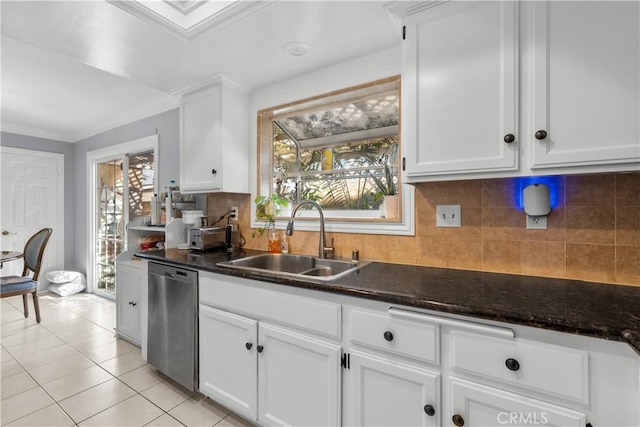 kitchen with light tile patterned floors, dishwasher, ornamental molding, white cabinetry, and a sink