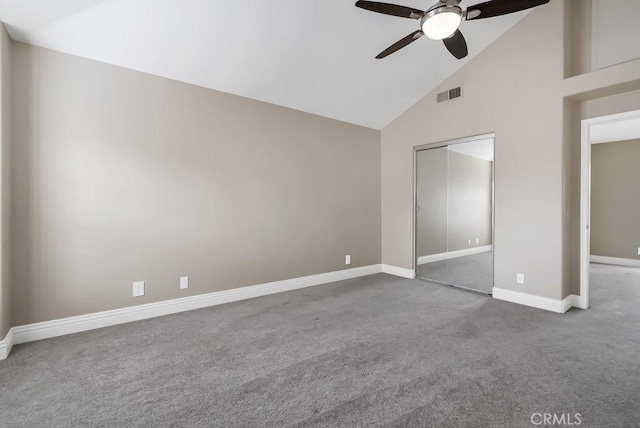 unfurnished bedroom featuring high vaulted ceiling, carpet flooring, visible vents, baseboards, and a closet