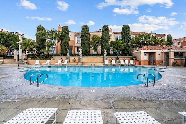 view of pool featuring a patio area and fence