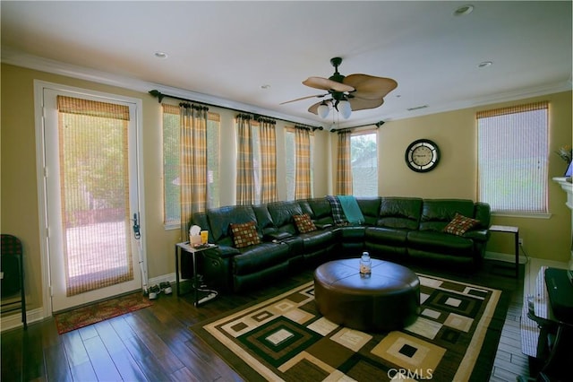 living room featuring ornamental molding, a ceiling fan, hardwood / wood-style flooring, and baseboards