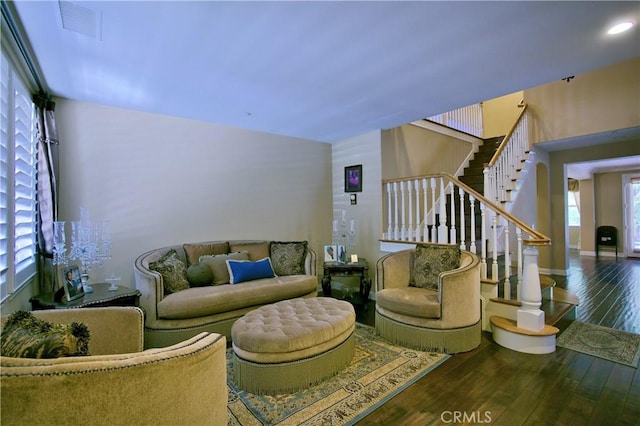 living room with recessed lighting, visible vents, baseboards, stairs, and hardwood / wood-style floors