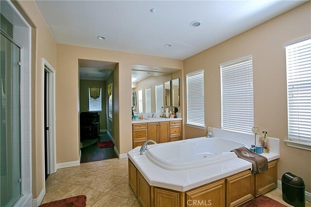 full bathroom with a stall shower, tile patterned flooring, a tub with jets, and vanity