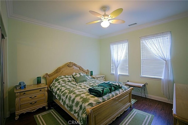 bedroom with a ceiling fan, visible vents, baseboards, ornamental molding, and dark wood finished floors