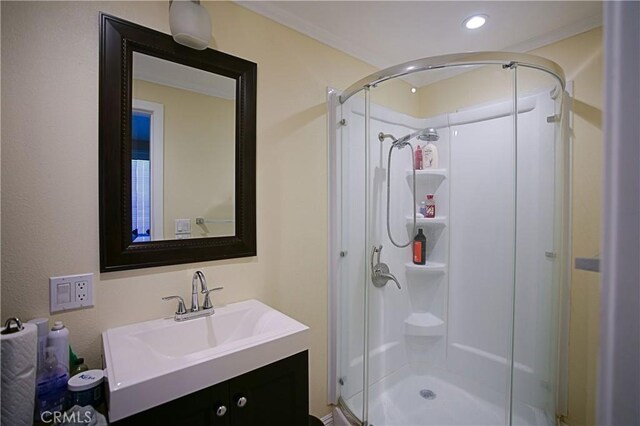 full bath with a stall shower, vanity, and recessed lighting