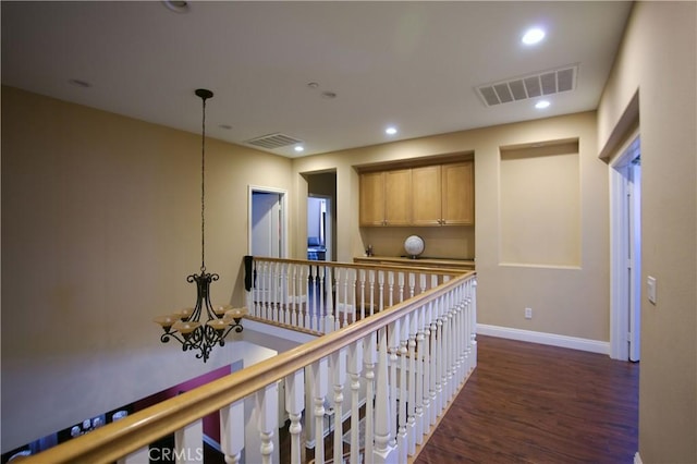 hallway with visible vents, dark wood-type flooring, and recessed lighting