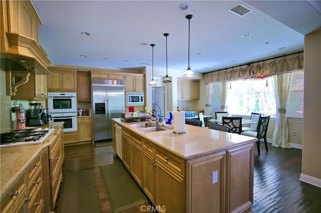 kitchen featuring recessed lighting, visible vents, dark wood-type flooring, a sink, and built in appliances