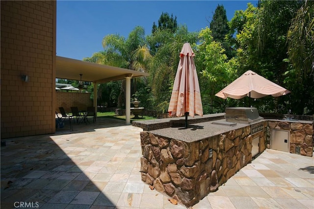 view of patio featuring fence and area for grilling