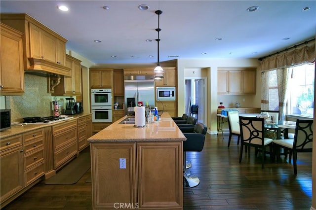 kitchen featuring dark wood-style floors, a kitchen island with sink, custom range hood, and built in appliances