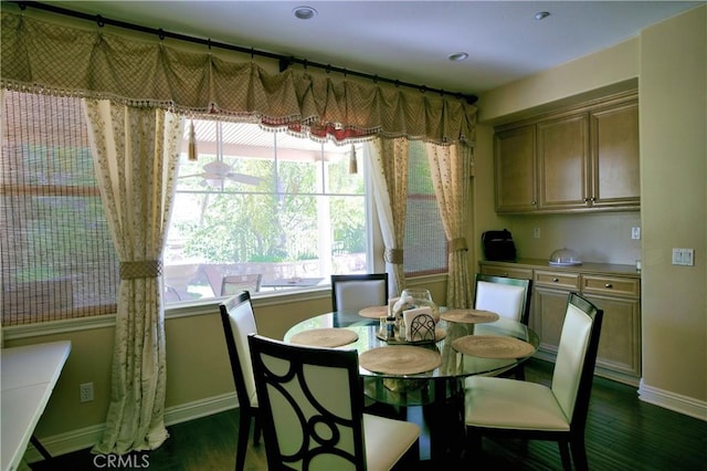 dining room with dark wood-type flooring and baseboards