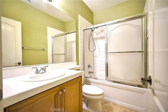 full bathroom featuring visible vents, toilet, tile patterned floors, vanity, and enclosed tub / shower combo