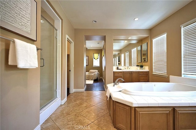 ensuite bathroom featuring a bath, vanity, tile patterned flooring, and a shower stall