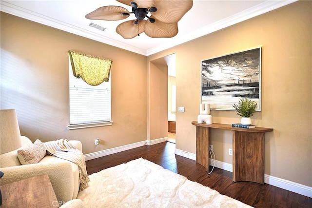 bedroom with baseboards, visible vents, wood finished floors, and crown molding