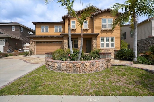 craftsman-style house with stone siding, a garage, concrete driveway, and a front yard