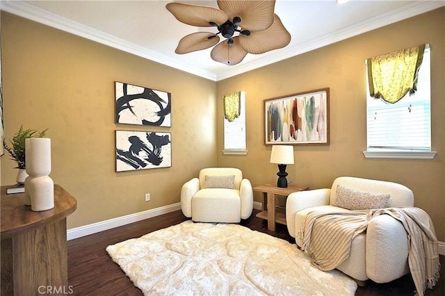 sitting room featuring baseboards, ornamental molding, wood finished floors, and ceiling fan