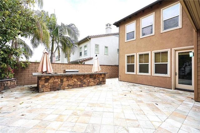 view of patio / terrace with fence and an outdoor kitchen