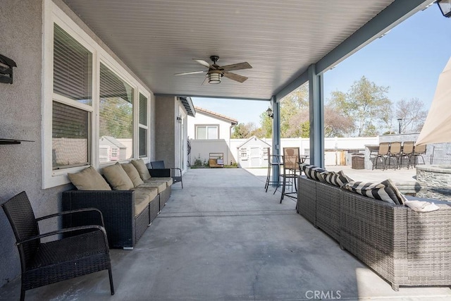 view of patio with ceiling fan, a fenced backyard, outdoor dry bar, and an outdoor hangout area