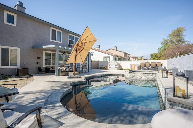 view of pool featuring central AC, a fenced backyard, an outdoor hangout area, ceiling fan, and a patio area