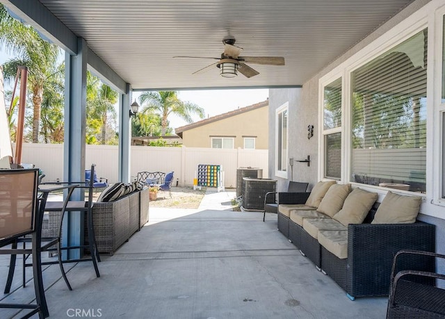 view of patio / terrace with an outdoor living space, central AC, a ceiling fan, and fence