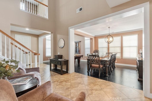 interior space featuring visible vents, plenty of natural light, stairway, and baseboards