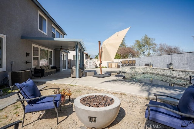 view of patio / terrace featuring an outbuilding, cooling unit, a fenced in pool, a fenced backyard, and ceiling fan