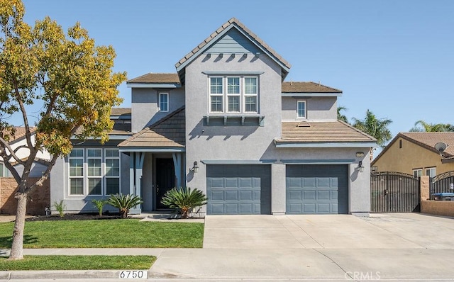 traditional home featuring concrete driveway, a gate, an attached garage, and stucco siding