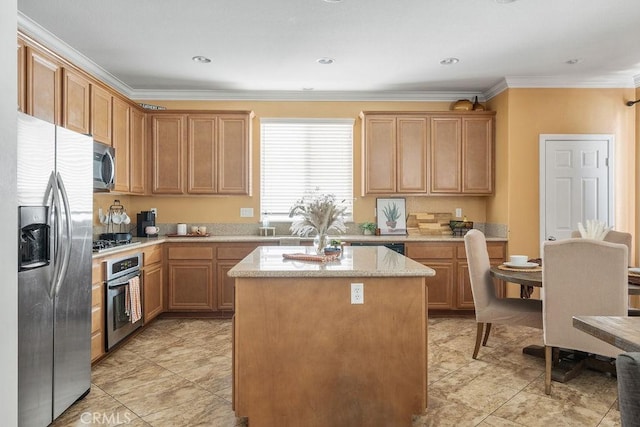 kitchen with a center island, light stone countertops, stainless steel appliances, and ornamental molding