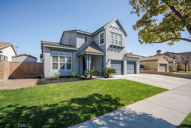 view of front of home featuring a front lawn, fence, stucco siding, driveway, and an attached garage