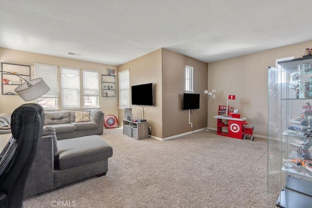 carpeted living area with visible vents, baseboards, and a textured ceiling