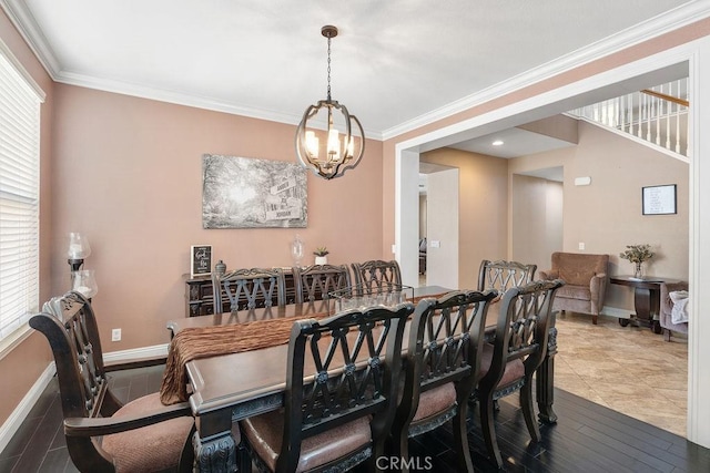 dining area featuring a notable chandelier, plenty of natural light, baseboards, and ornamental molding