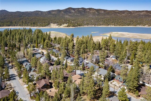 birds eye view of property with a residential view, a water view, and a wooded view