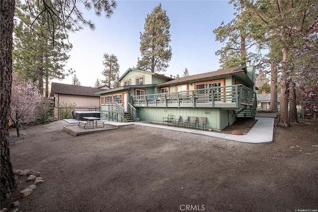 back of house featuring stairway, a patio area, a wooden deck, and central air condition unit