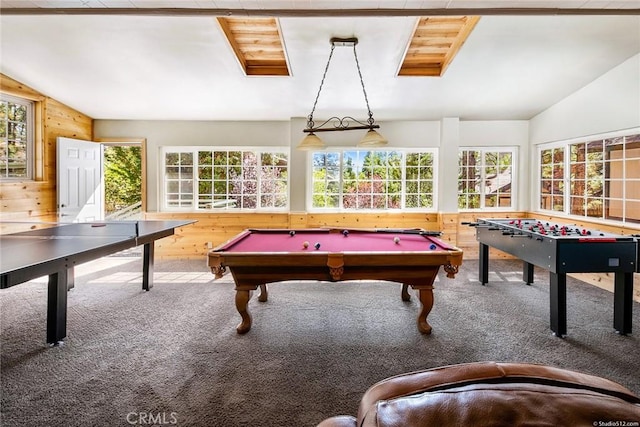 playroom with wood walls, carpet, and vaulted ceiling