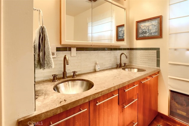 full bath with a sink, backsplash, and double vanity