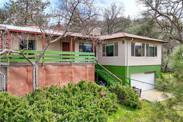 single story home with an attached garage, stairs, and a chimney