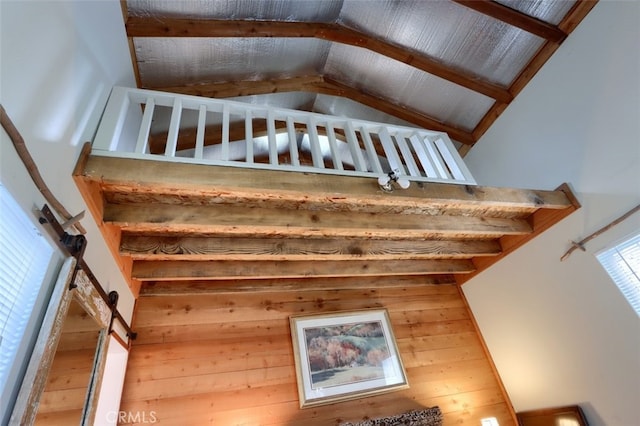 interior space with high vaulted ceiling and beam ceiling