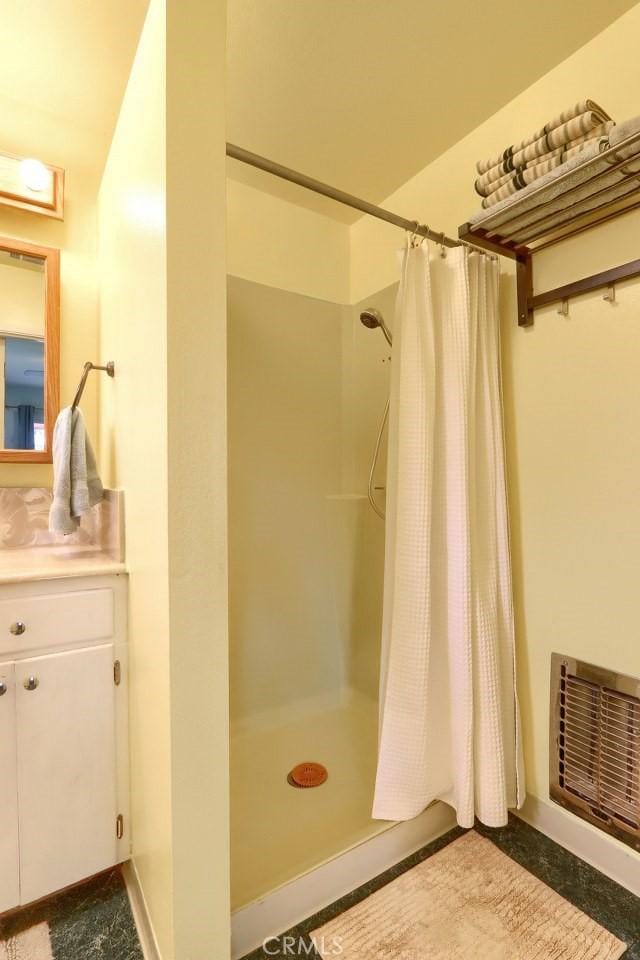 full bath with a shower with curtain and vanity