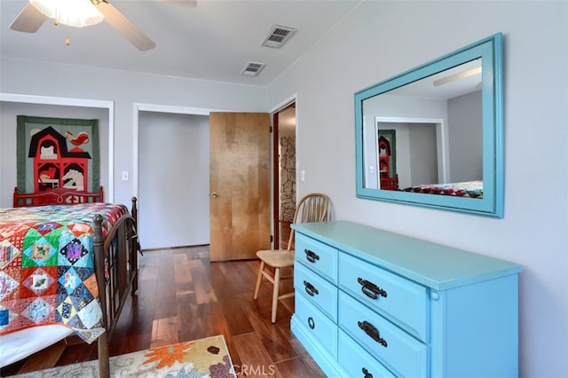 bedroom with dark wood-style floors, visible vents, and ceiling fan