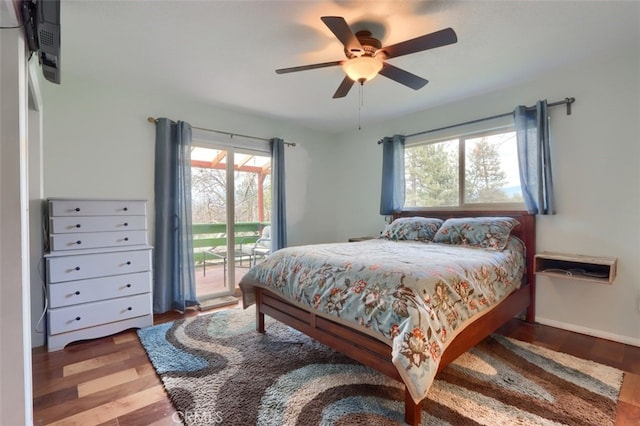 bedroom featuring a ceiling fan, access to outside, baseboards, and wood finished floors