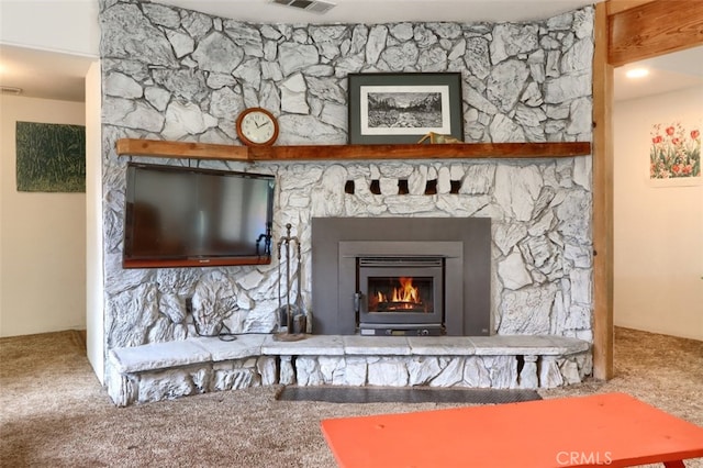 room details with carpet, a glass covered fireplace, and visible vents